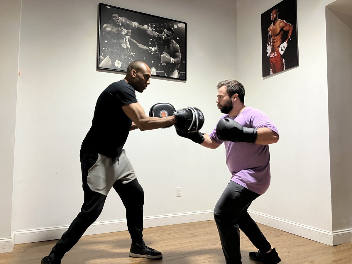 One-on-one pad work coaching at Central Park Boxing